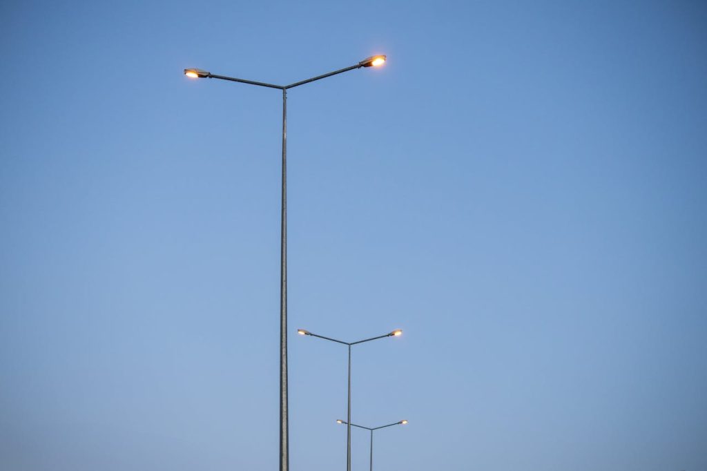 Symmetrical row of street lights extending into clear blue sky during the day in Palu, Elazığ, Türkiye.